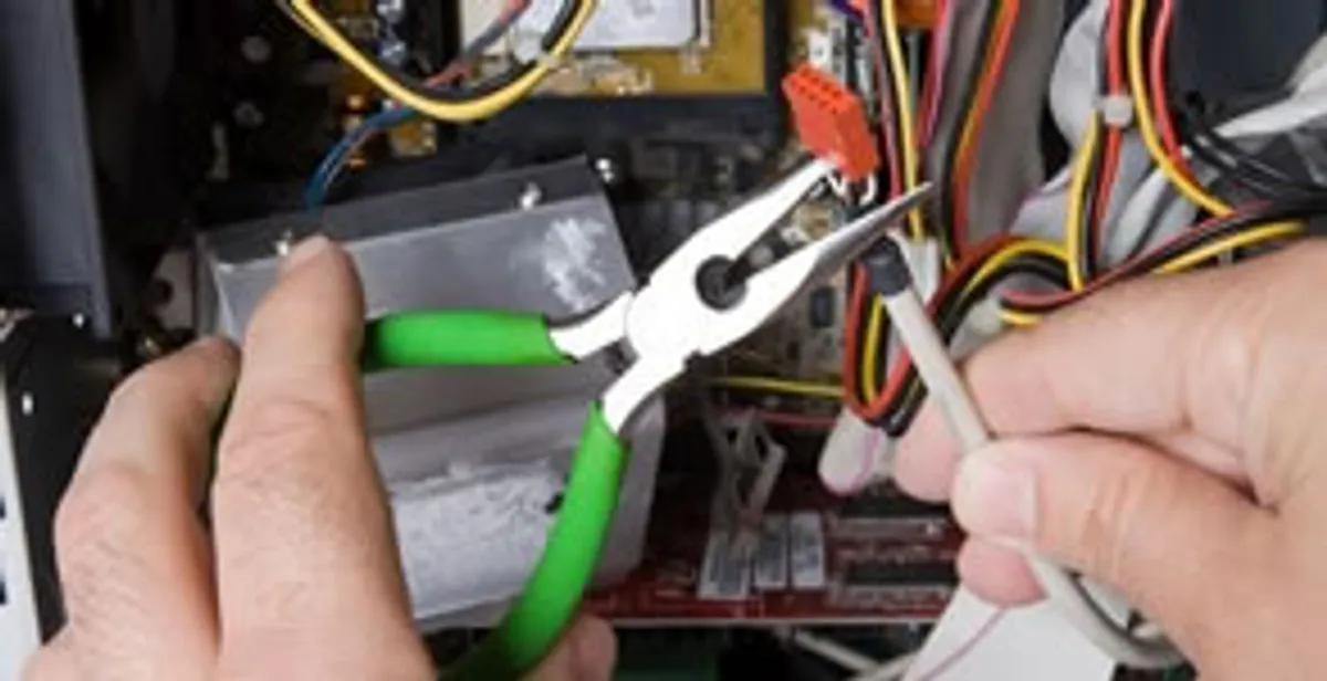 Licensed electrical contractor performing electrical repair with tools in Escalon, CA